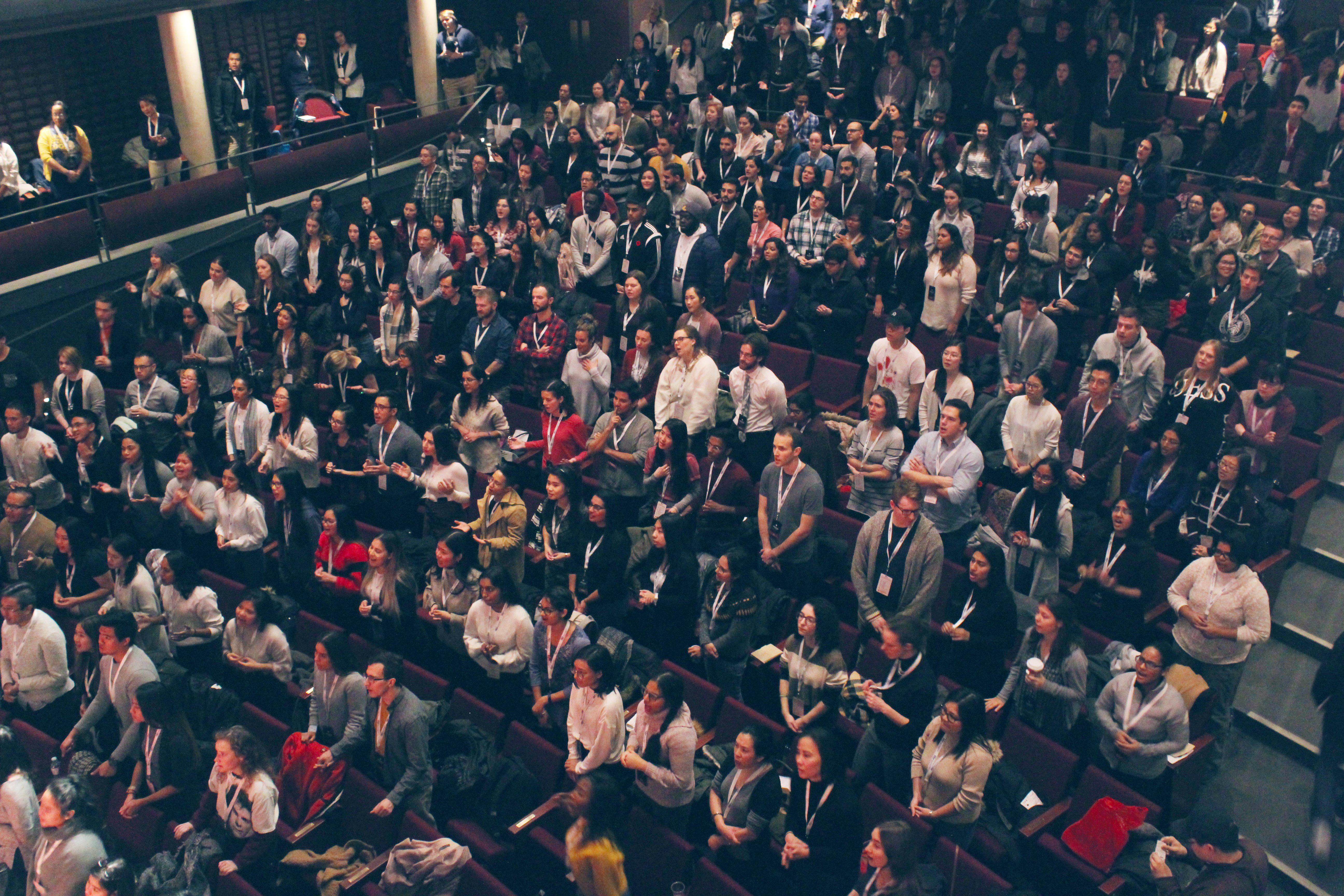 Crowd of young adults gathered inside a large theatre for the Renew Young Adult conference